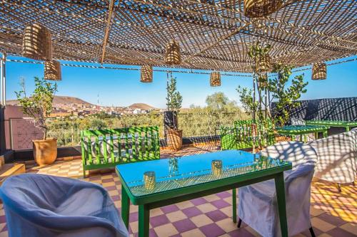 a patio with a table and chairs and a view at LE Piccolo Bike Camp in El Karia