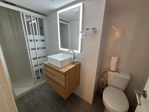 a bathroom with a sink and a toilet and a mirror at Apartment close Barcelona - Rentals Badalona Beach - Free Parking in Badalona