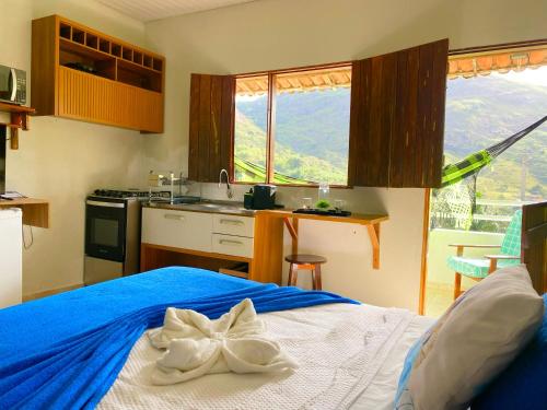 a bedroom with a blue bed with a bow on it at Aptos e Flats condomínio Pedra do Rodeadouro in Bonito