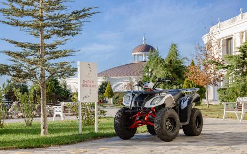 a four wheeler parked in front of a building at Shamakhi Palace Sharadil in Şǝrǝdil