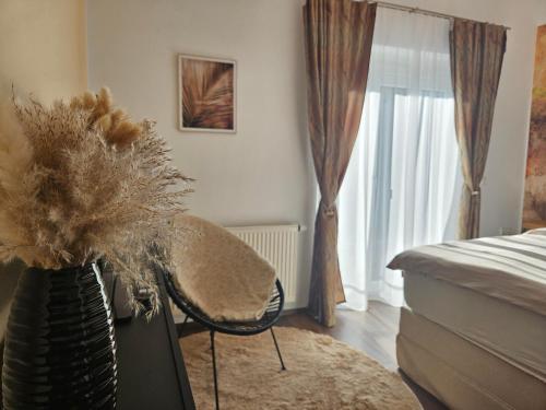a bedroom with a bed and a vase with a plant at Ferienwohnung Blick ins Grüne in Rossleithen