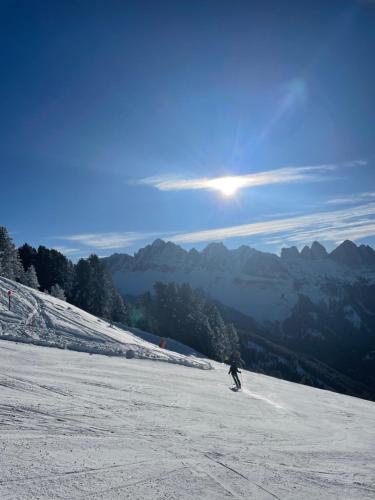a person is skiing down a snow covered slope at Pension Moarhof in Feldthurns