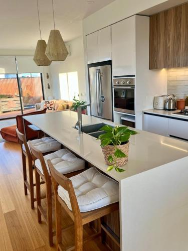 a kitchen with a large white island in a room at Bright, spacious apartment in Torquay in Torquay