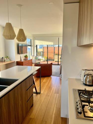 an open kitchen and living room in a house at Bright, spacious apartment in Torquay in Torquay