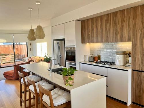 a kitchen with a large white island in a room at Bright, spacious apartment in Torquay in Torquay