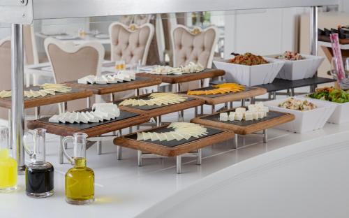 a buffet with a lot of food on display at Shamakhi Palace Sharadil in Şǝrǝdil
