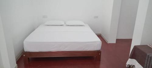 a bed in a room with a white mattress at Villa Paradiso in Wadduwa