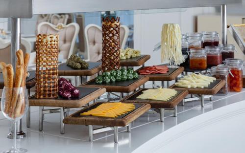 a buffet with many different types of food on trays at Shamakhi Palace Sharadil in Şǝrǝdil
