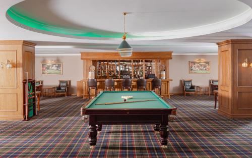 a billiard room with a pool table and chairs at Shamakhi Palace Sharadil in Şǝrǝdil