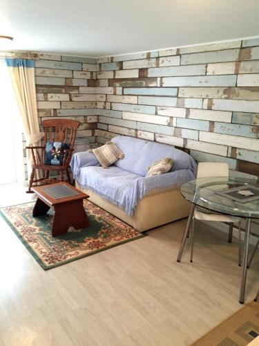 a living room with a couch and a table at Lark Rise B&B in Wangford