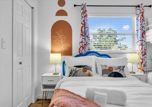 a bedroom with a white bed with a window at 3BR Sunshine Retreat with Heated Pool, Cold Plunge and Games in Bradenton