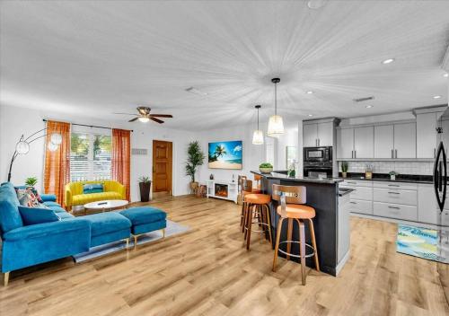 a kitchen and living room with a blue couch at 3BR Sunshine Retreat with Heated Pool, Cold Plunge and Games in Bradenton