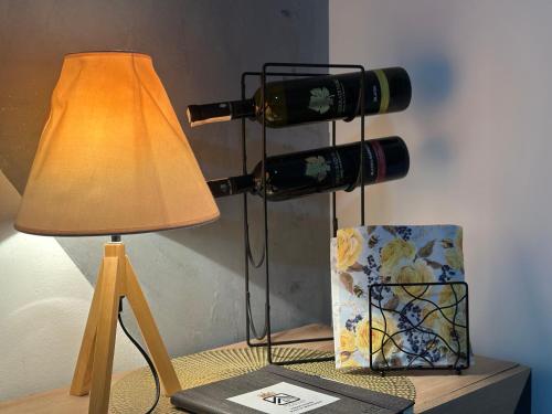 a table with a lamp and a bottle of wine at Hedonist Spa Jacuzzi Sarajevo Free parking in Sarajevo
