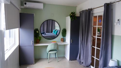a room with a chair and a mirror at 4BlessingsCuracao2 in Willemstad