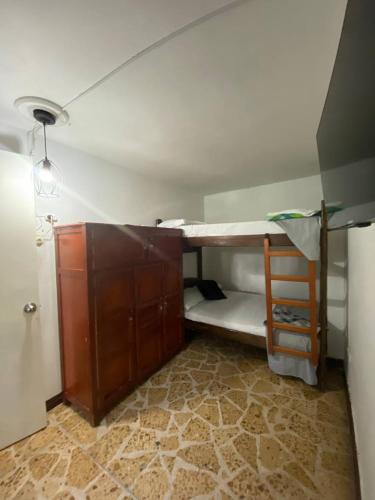 a small room with a bunk bed and a desk at hostal casa prado in in Medellín