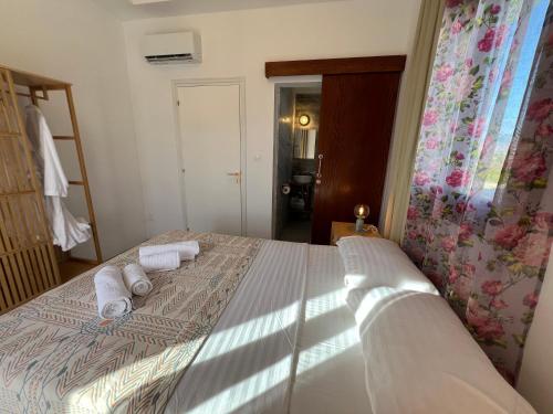 a bedroom with a bed with towels on it at First Eco-Villa in Polis Chrysochous