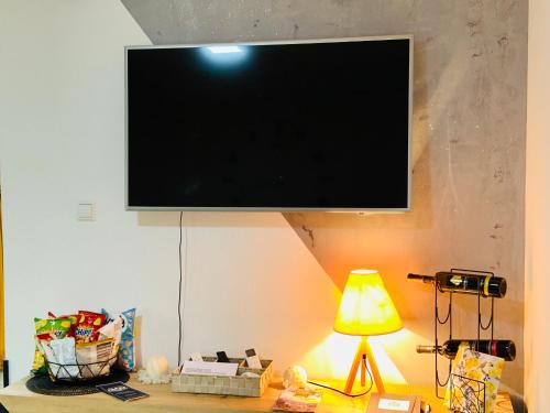a flat screen tv hanging on a wall at Hedonist Spa Jacuzzi Sarajevo Free parking in Sarajevo