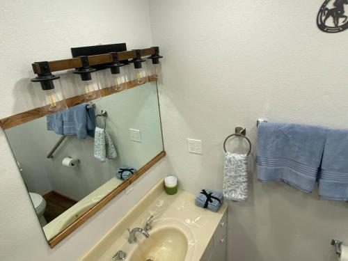 a bathroom with a sink and a mirror at Zion to Bryce cowboy cabin in Hatch