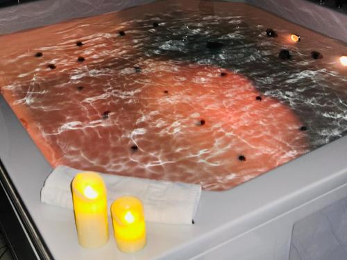 a piece of meat in a refrigerator with two candles at Hedonist Spa Jacuzzi Sarajevo Free parking in Sarajevo