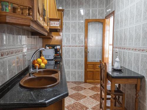 a kitchen with a sink and fruit on the counter at Country House Cuevas Bajas by Genil River in Cuevas Bajas