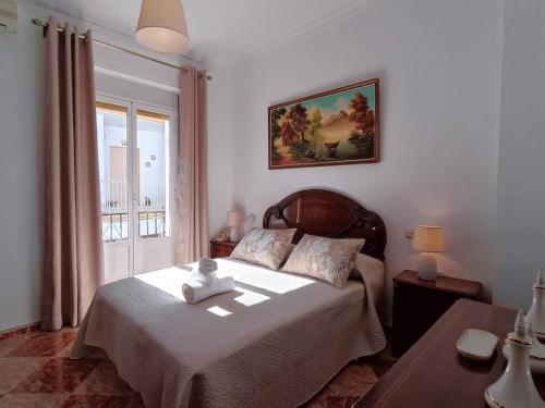 a bedroom with a bed with a teddy bear on it at Country House Cuevas Bajas by Genil River in Cuevas Bajas