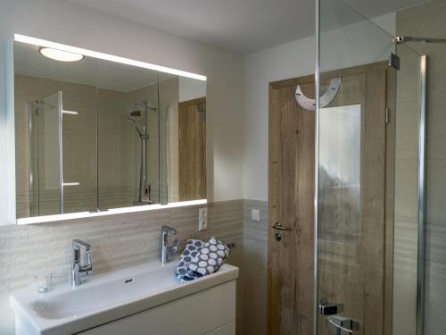 a bathroom with a sink and a glass shower at Mill Pond Luxury Escape in Hemschlar