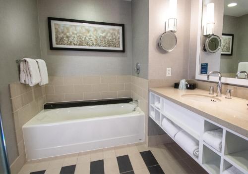 a bathroom with a tub and a sink at Caesars Windsor Hotel and Casino in Windsor