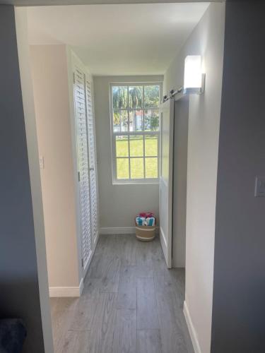 an empty hallway with a window in a house at A Cozy Condo at Sea Castles in Montego Bay
