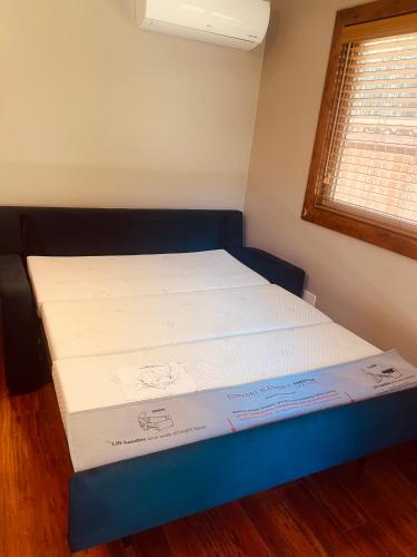 a bed in a room with a blue and white mattress at Luxury Single Level, Great Location, Hot Tub, Arcade in South Lake Tahoe
