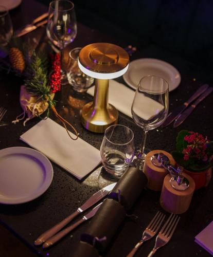 a table with plates and wine glasses on it at Best Western Northfields Ealing Hotel in London
