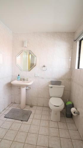 a bathroom with a toilet and a sink at Casa Lomas Cozy 3 Bedroom 2 Bath House by Xolos Stadium in Tijuana