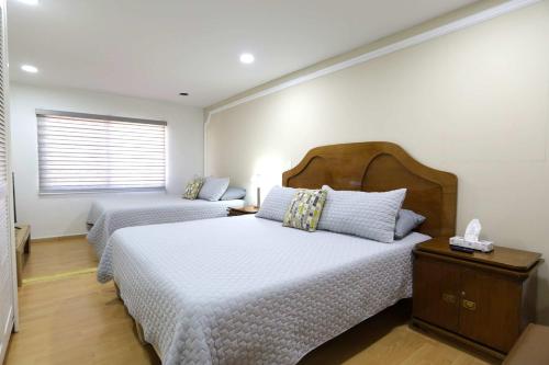 a bedroom with two beds and a window at Casa Lomas Cozy 3 Bedroom 2 Bath House by Xolos Stadium in Tijuana