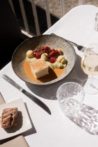a bowl of food on a table with a plate of food at Château des Comtes de Challes in Challes-les-Eaux
