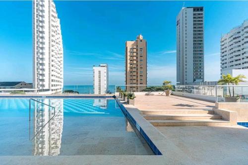 une piscine au milieu d'une ville avec de grands bâtiments dans l'établissement New Apartments with great Sunsets near historic center and beach, à Carthagène des Indes
