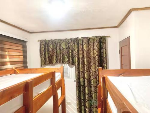 a room with a window with a curtain at Cozy Room Good for 4pax in San Juan