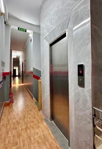 a hallway with a elevator in a building at Nam Đô Hotel Cần Thơ Downtown in Can Tho