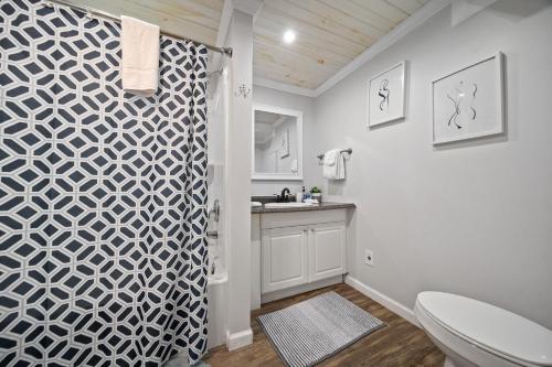 a bathroom with a shower with a toilet and a sink at Hidden Ranch in Sevierville
