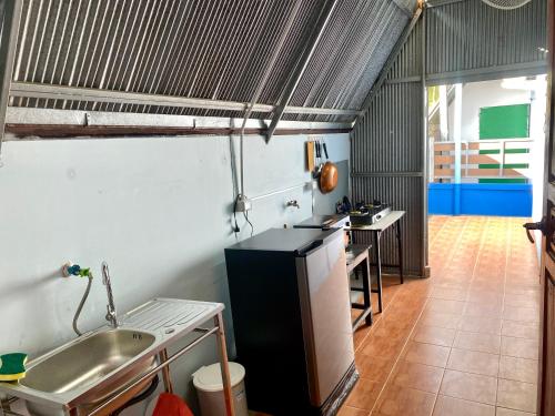 a kitchen with a sink and a counter top at Solar cell rental house in Chiang Rai