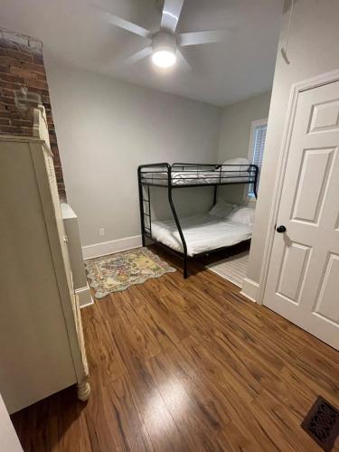 a room with a bed and a ceiling fan at Sparkle City Cottage in Spartanburg