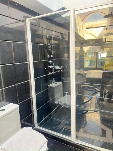a bathroom with a glass shower with a toilet at V20 Boutique Jacuzzi Hotel in Bangkok