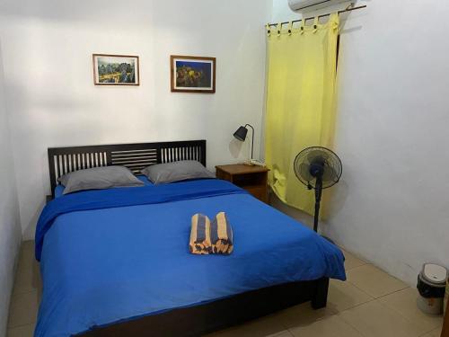 Ένα ή περισσότερα κρεβάτια σε δωμάτιο στο Dive Timor Guesthouse and Apartments