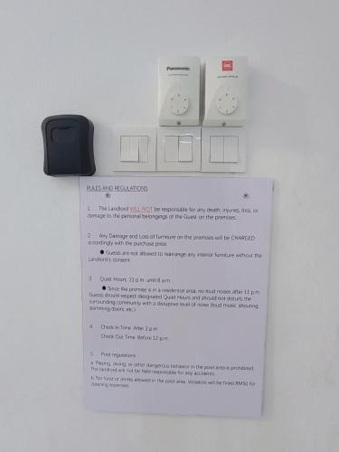 a piece of paper on a wall with an electronic device at Serena Villa Mslim Only With Indoor Private Pool in Port Dickson