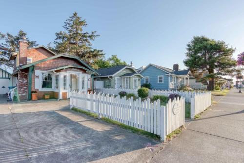 a white picket fence in front of houses at Taft Cottage in Lincoln City