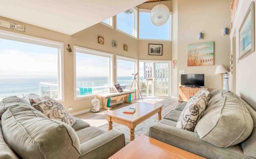 a living room with a couch and a table at Seas the Day in Lincoln City