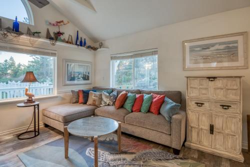 a living room with a couch and a table at Rememberance in Depoe Bay