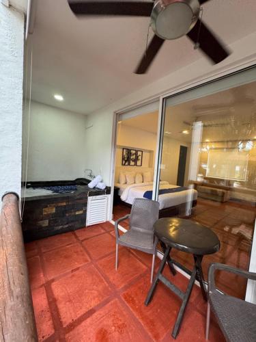 a bedroom with a bed and a table and chairs at Hotel Boutique Villas de San Sebastián in Villavicencio