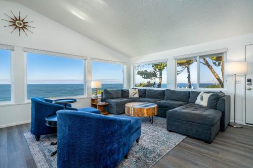 a living room with a couch and chairs and the ocean at Lawtons View in Lincoln City