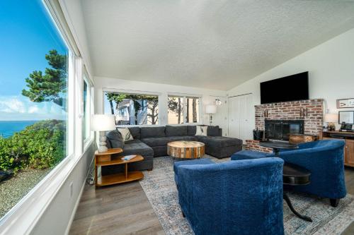 a living room with a couch and a fireplace at Lawtons View in Lincoln City