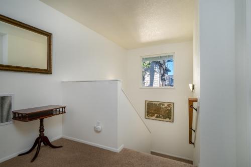 a white room with a table and a mirror at Lawtons View in Lincoln City