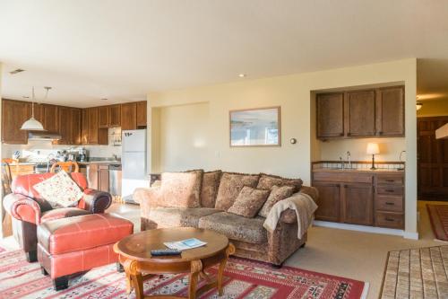 a living room with a couch and a table at Commodore 1 in Depoe Bay
